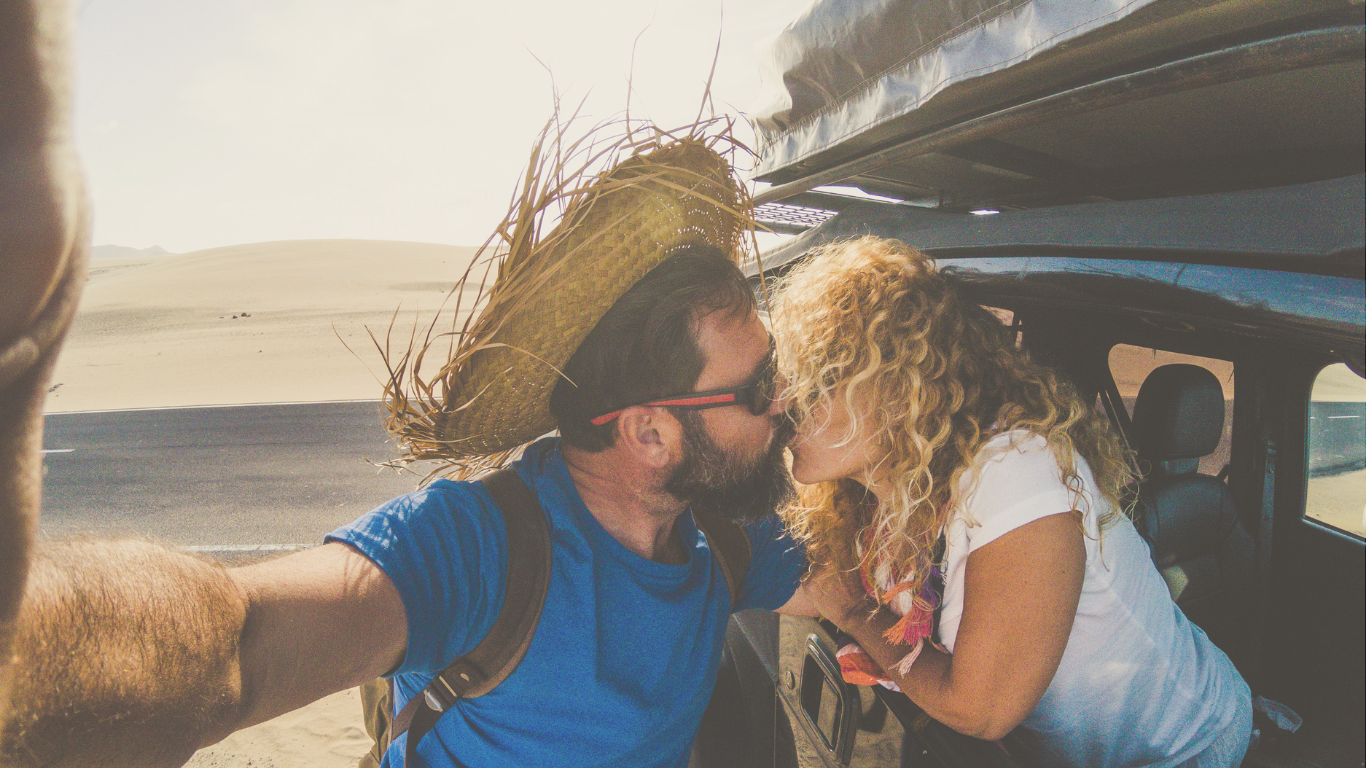 A couple telecommuting from inside their camper van, combining remote work with van life adventures.